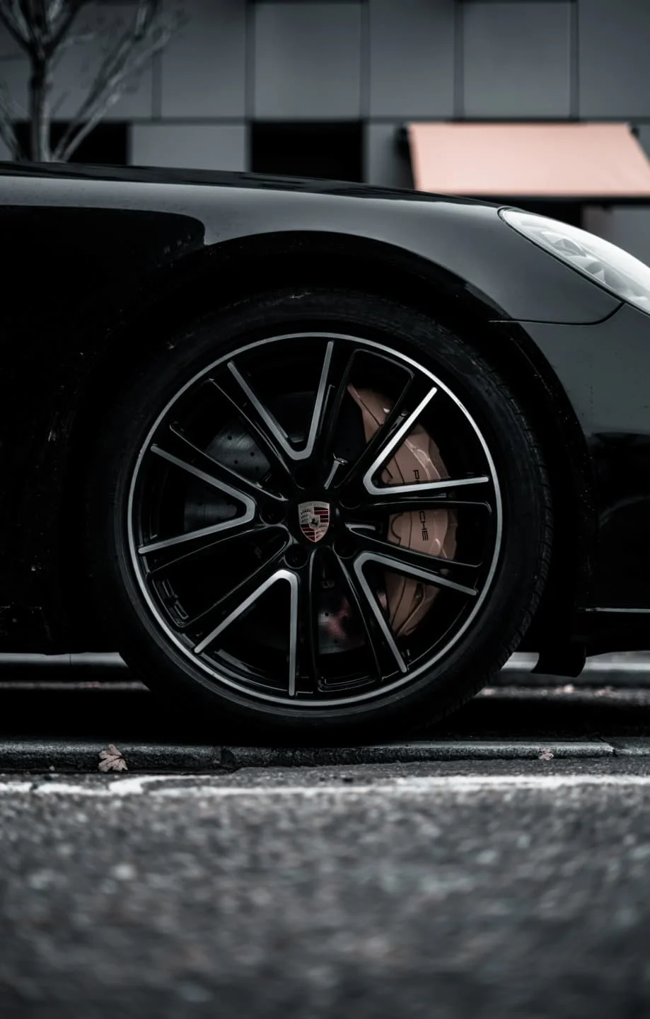 A close-up shot of a block Porsche with diamond cut alloys
