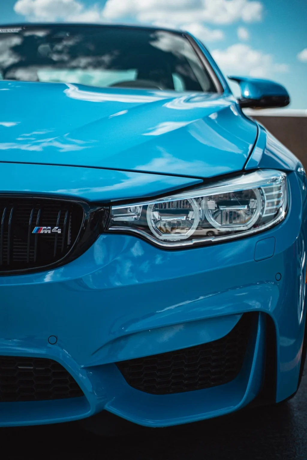 Close-up front shot of a turquoise BMW M4