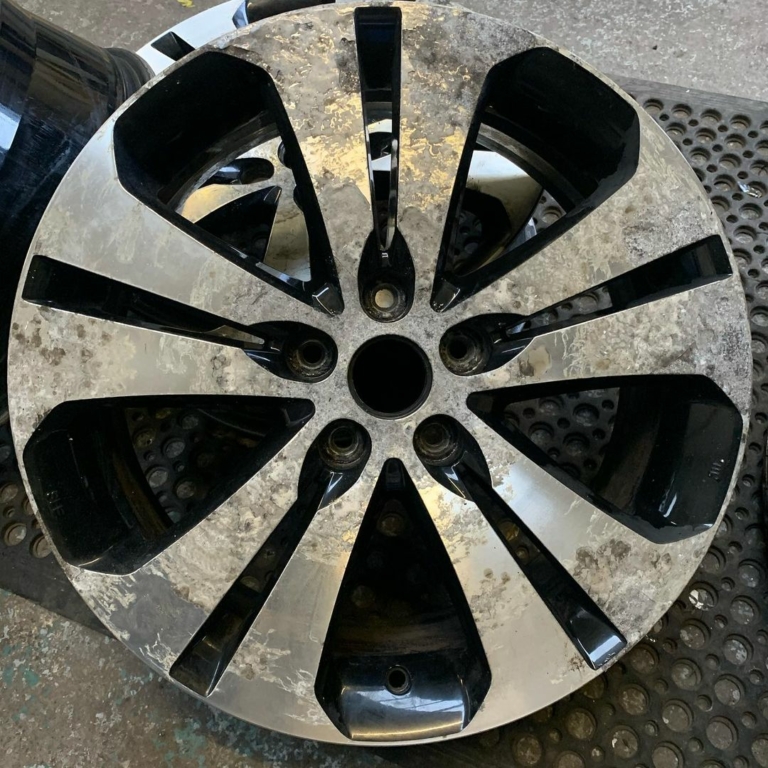 A scuffed, scratched and damaged alloy wheel before the diamond cut refurbishing process