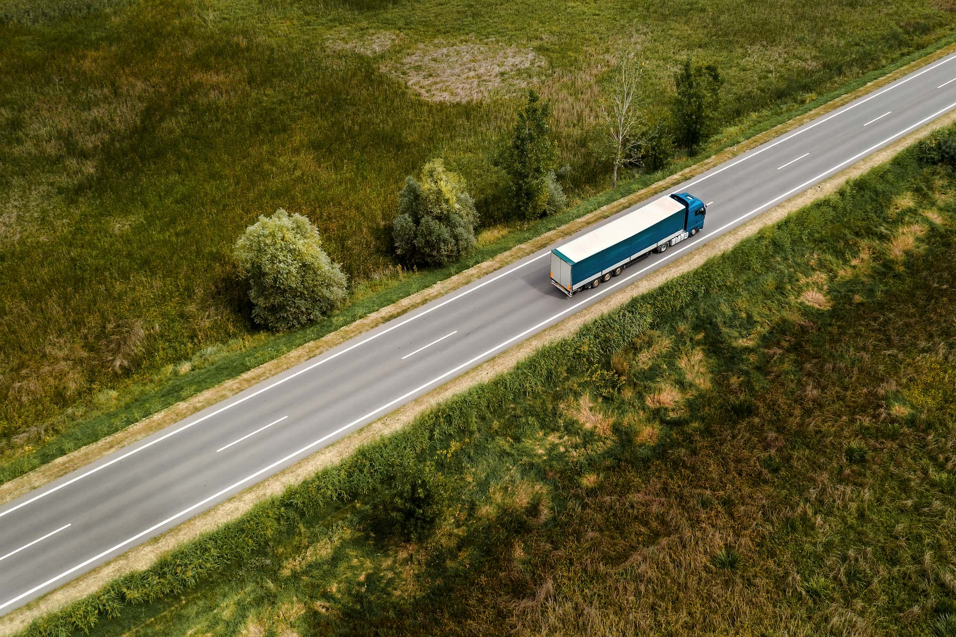 A large semi-truck on the road delivering a used car to a customer